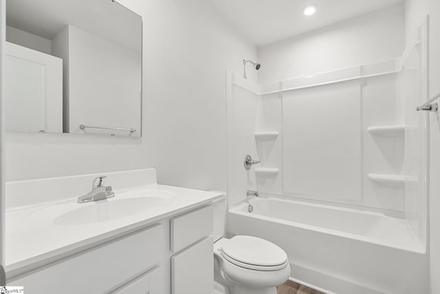 bathroom featuring wood finished floors, vanity, toilet, bathing tub / shower combination, and recessed lighting