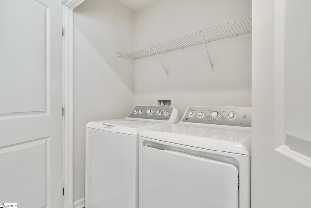 washroom with separate washer and dryer and laundry area