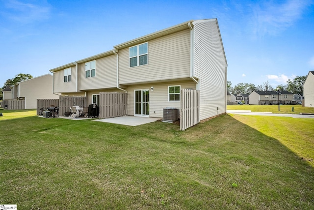 back of property featuring a patio, a lawn, fence, and cooling unit