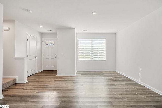 unfurnished room with baseboards, recessed lighting, and wood finished floors