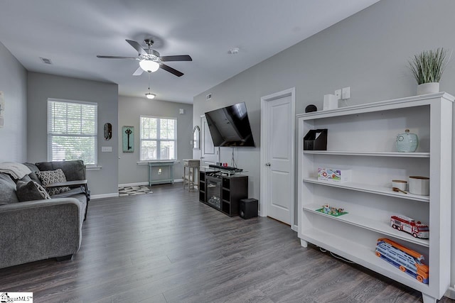 living room with visible vents, a ceiling fan, dark wood finished floors, and baseboards
