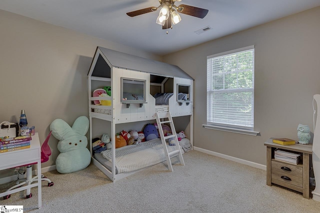 bedroom with carpet floors, baseboards, ceiling fan, and visible vents