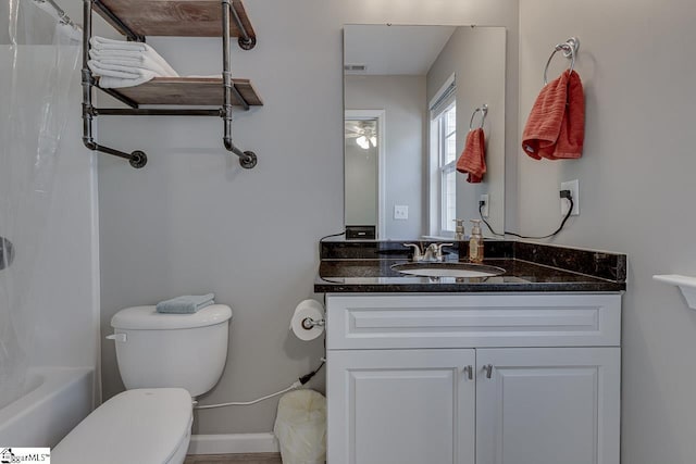 bathroom featuring vanity, baseboards, toilet, and visible vents