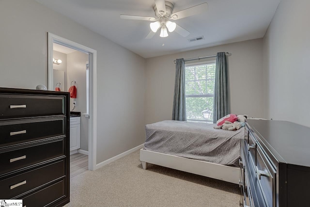 bedroom with light colored carpet, baseboards, visible vents, and ceiling fan