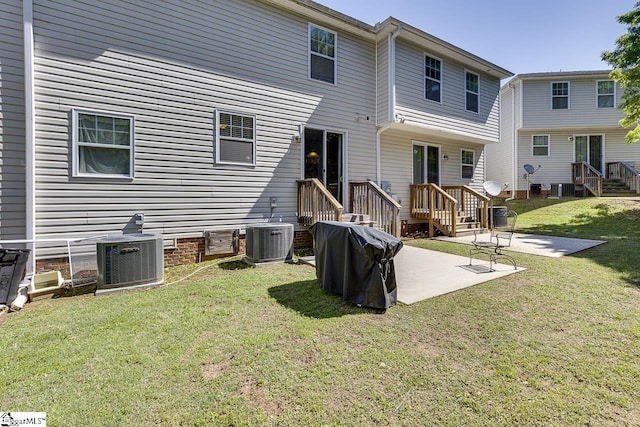 back of house featuring a patio, a lawn, and cooling unit