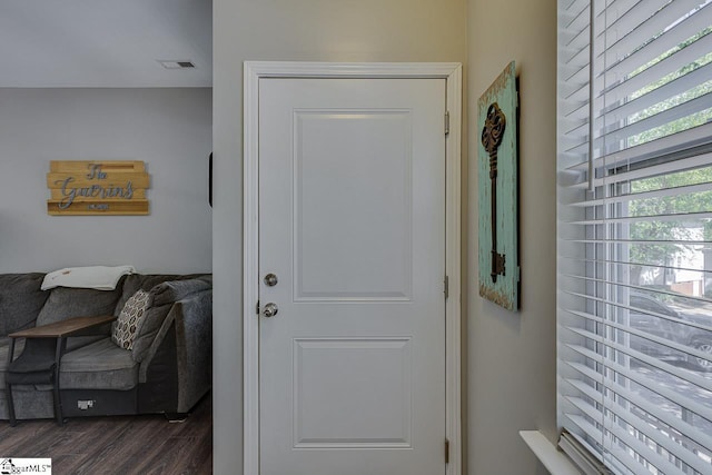 doorway to outside featuring visible vents and dark wood-style floors