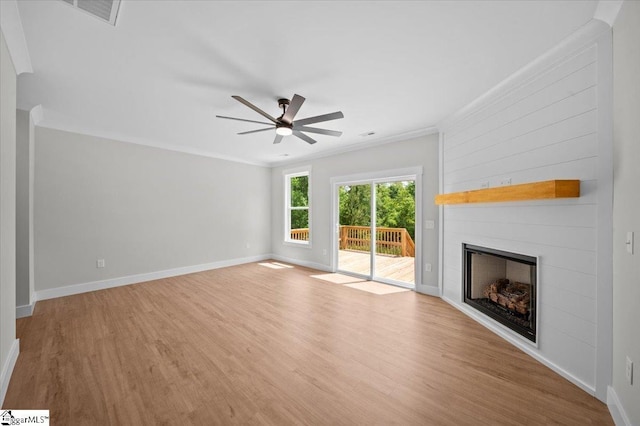 13 Lyman Lake Rd, Lyman, SC 29365 - unfurnished living room featuring crown molding, ceiling fan, wood finished floors, and a fireplace