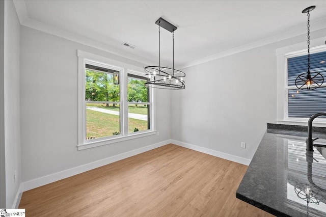 13 Lyman Lake Rd, Lyman, SC 29365 - unfurnished dining area with crown molding, an inviting chandelier, light wood finished floors, baseboards, and visible vents
