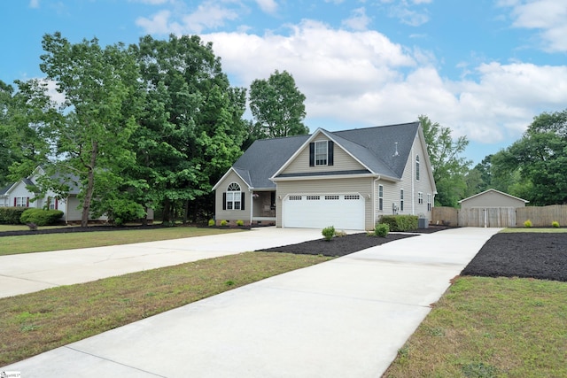 view of front of home featuring fence, driveway, a front yard, and cooling unit