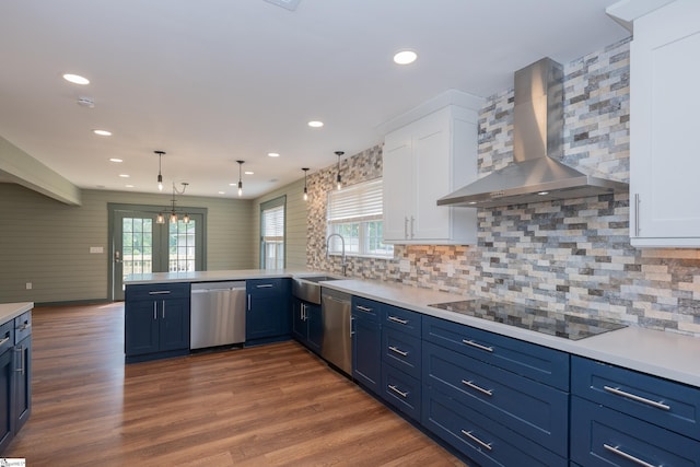 kitchen featuring wall chimney range hood, black electric stovetop, a sink, and dishwasher