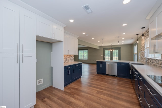 kitchen with stainless steel dishwasher, visible vents, a sink, recessed lighting, and blue cabinets