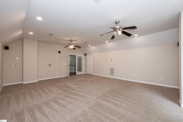 unfurnished living room featuring carpet, a ceiling fan, vaulted ceiling, and visible vents