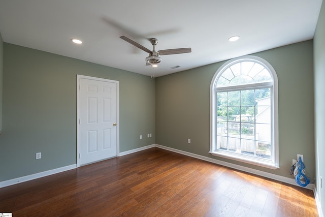 spare room featuring a ceiling fan, visible vents, baseboards, dark wood-style floors, and recessed lighting