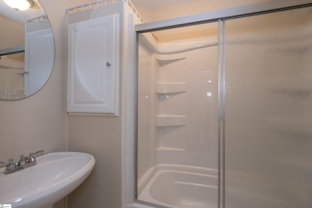 full bath with a sink and a stall shower