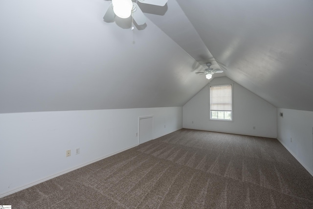 additional living space featuring vaulted ceiling, a ceiling fan, and carpet flooring