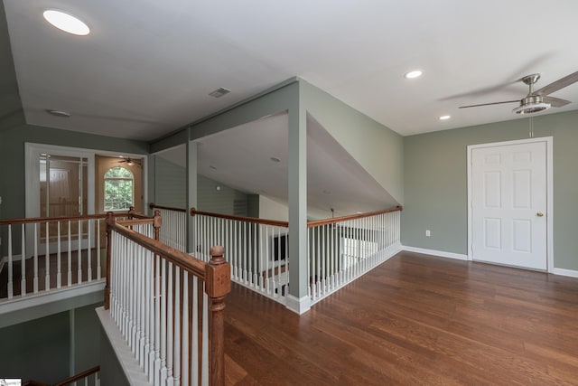 hall with baseboards, recessed lighting, wood finished floors, and an upstairs landing