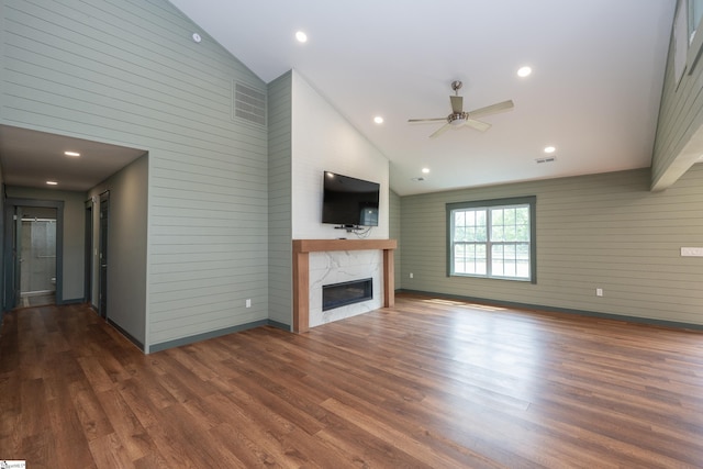 unfurnished living room with a ceiling fan, high vaulted ceiling, wood finished floors, and a high end fireplace