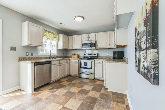 118 Wonderberry Ct, Boiling Springs, SC 29316 - kitchen featuring appliances with stainless steel finishes, baseboards, a sink, stone finish floors, and light countertops