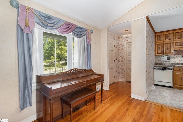 living area featuring crown molding, lofted ceiling, baseboards, light wood-style flooring, and a notable chandelier