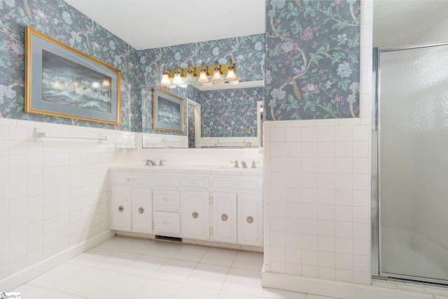 bathroom featuring a stall shower, a wainscoted wall, tile patterned floors, and wallpapered walls