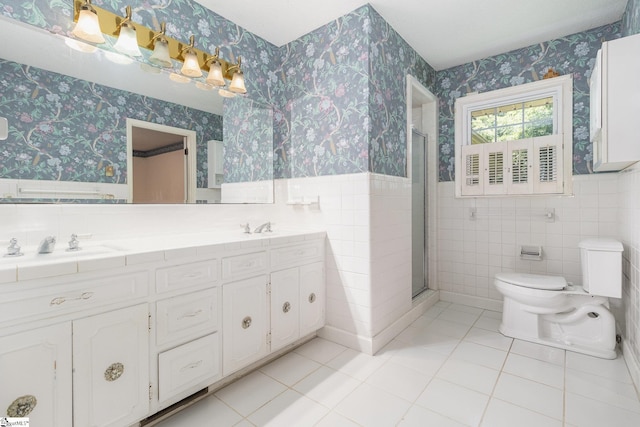 bathroom with wallpapered walls and tile walls