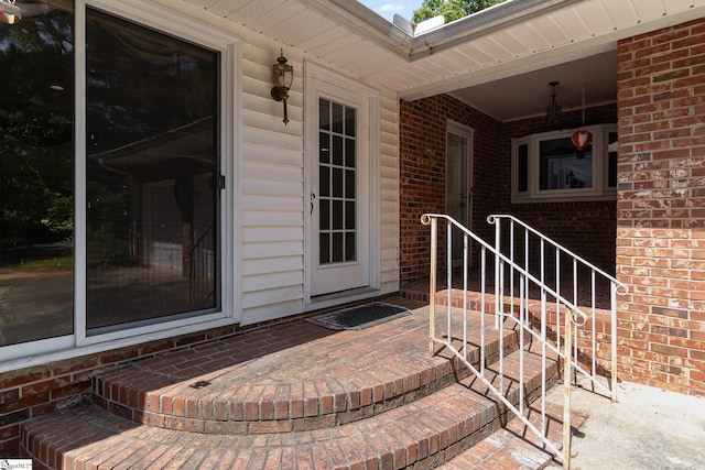 doorway to property with brick siding