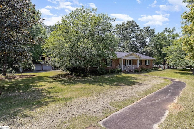 view of front of home with brick siding and a front yard