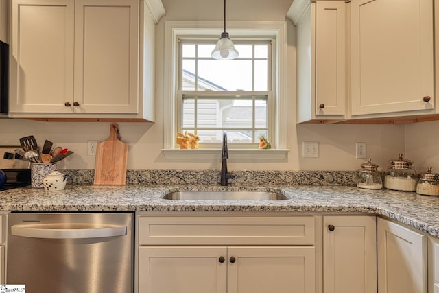 kitchen featuring white cabinets, pendant lighting, a sink, and dishwasher