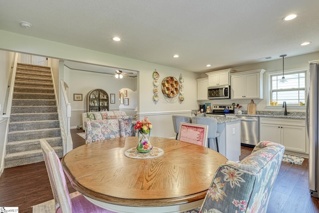 dining area featuring ceiling fan, recessed lighting, visible vents, dark wood-style floors, and stairway