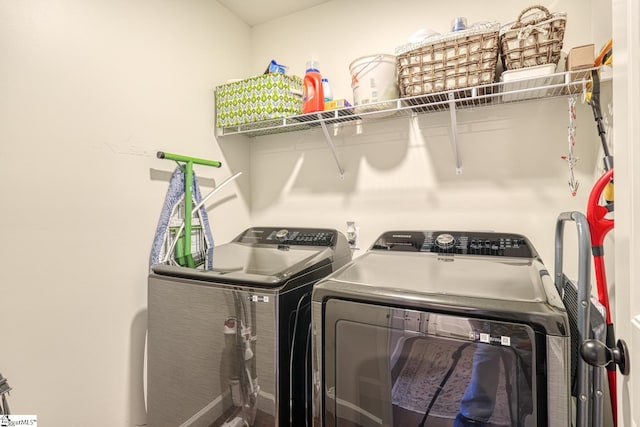 clothes washing area with laundry area and washing machine and clothes dryer
