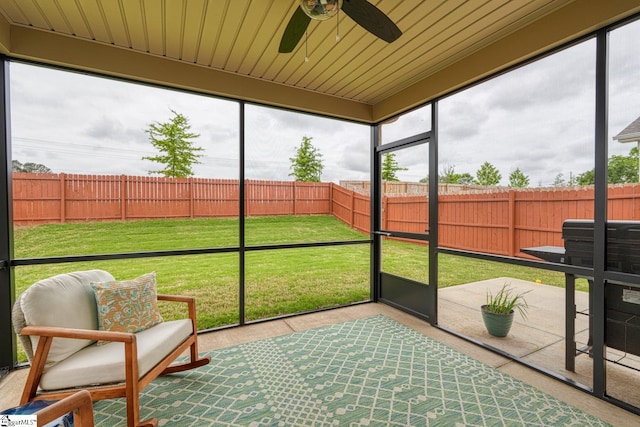 sunroom / solarium featuring a ceiling fan