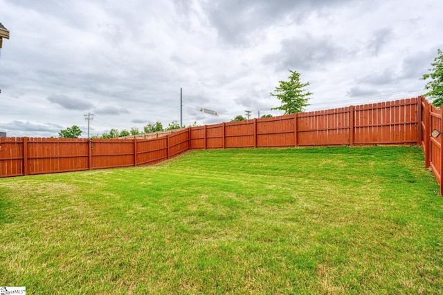 view of yard with a fenced backyard