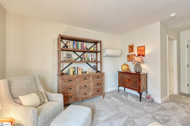 living area featuring baseboards, a wall mounted air conditioner, carpet, and a textured ceiling