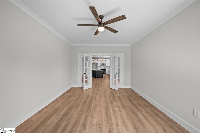 unfurnished living room with ceiling fan, ornamental molding, french doors, and wood finished floors