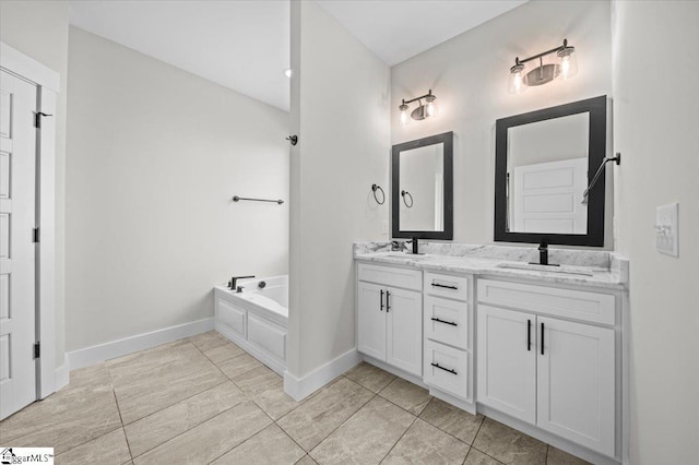 bathroom with double vanity, a bath, tile patterned flooring, a sink, and baseboards