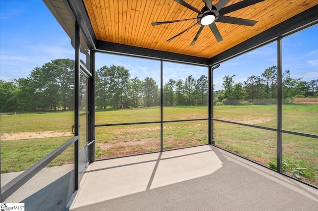 unfurnished sunroom featuring ceiling fan