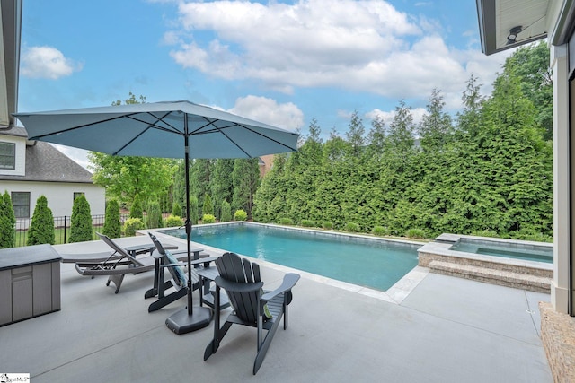 pool featuring fence, an in ground hot tub, and a patio area