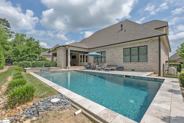 pool with a patio and fence