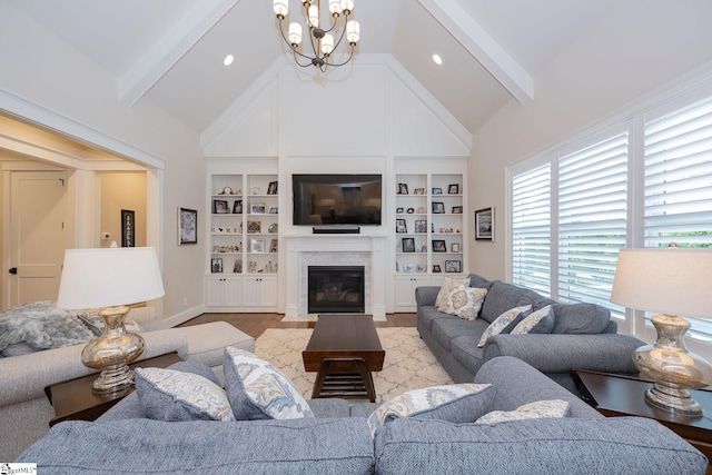 living area with an inviting chandelier, baseboards, wood finished floors, and beamed ceiling
