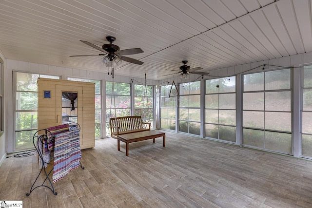 sunroom with ceiling fan and wood finished floors