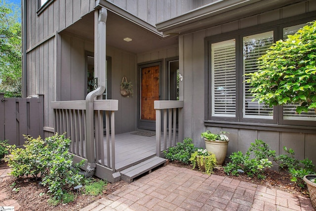 entrance to property with fence and a wooden deck