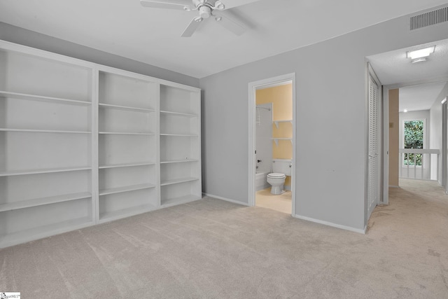 unfurnished bedroom featuring visible vents, connected bathroom, carpet, and baseboards
