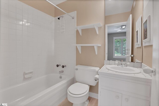 full bathroom with vanity, toilet, ceiling fan, tile patterned floors, and shower / washtub combination