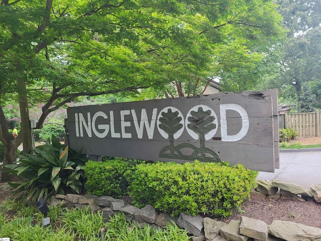 community / neighborhood sign with fence
