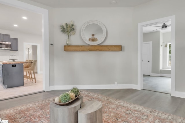 interior space with baseboards, recessed lighting, and wood finished floors