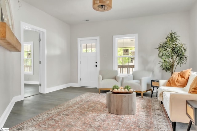 sitting room featuring baseboards and wood finished floors