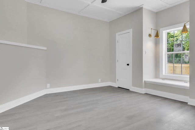 unfurnished room with baseboards and wood finished floors