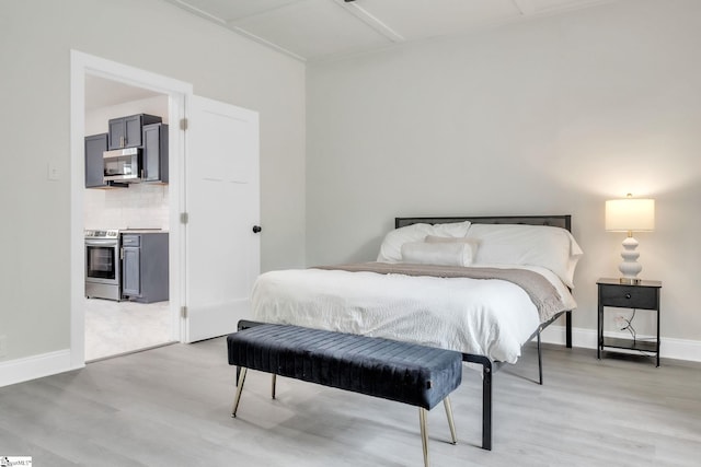 bedroom featuring light wood-type flooring and baseboards