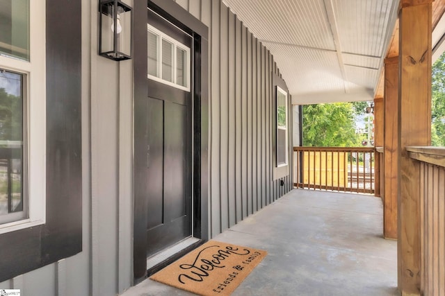 property entrance with a porch and board and batten siding