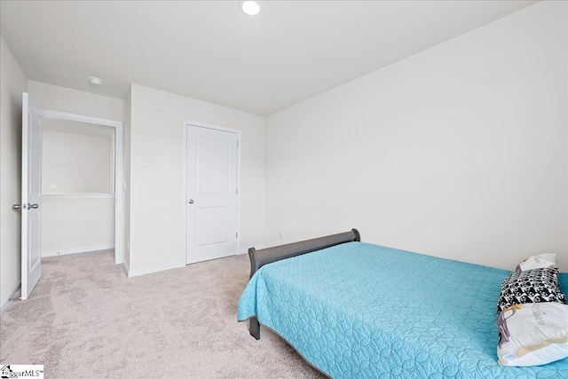 bedroom with baseboards and carpet flooring